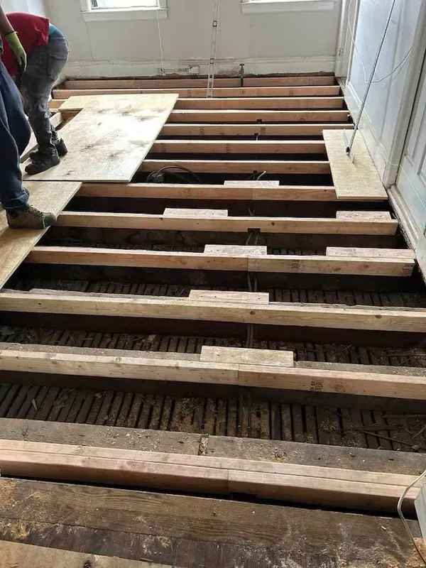 Floor joist repair and subfloor replacement during home renovation