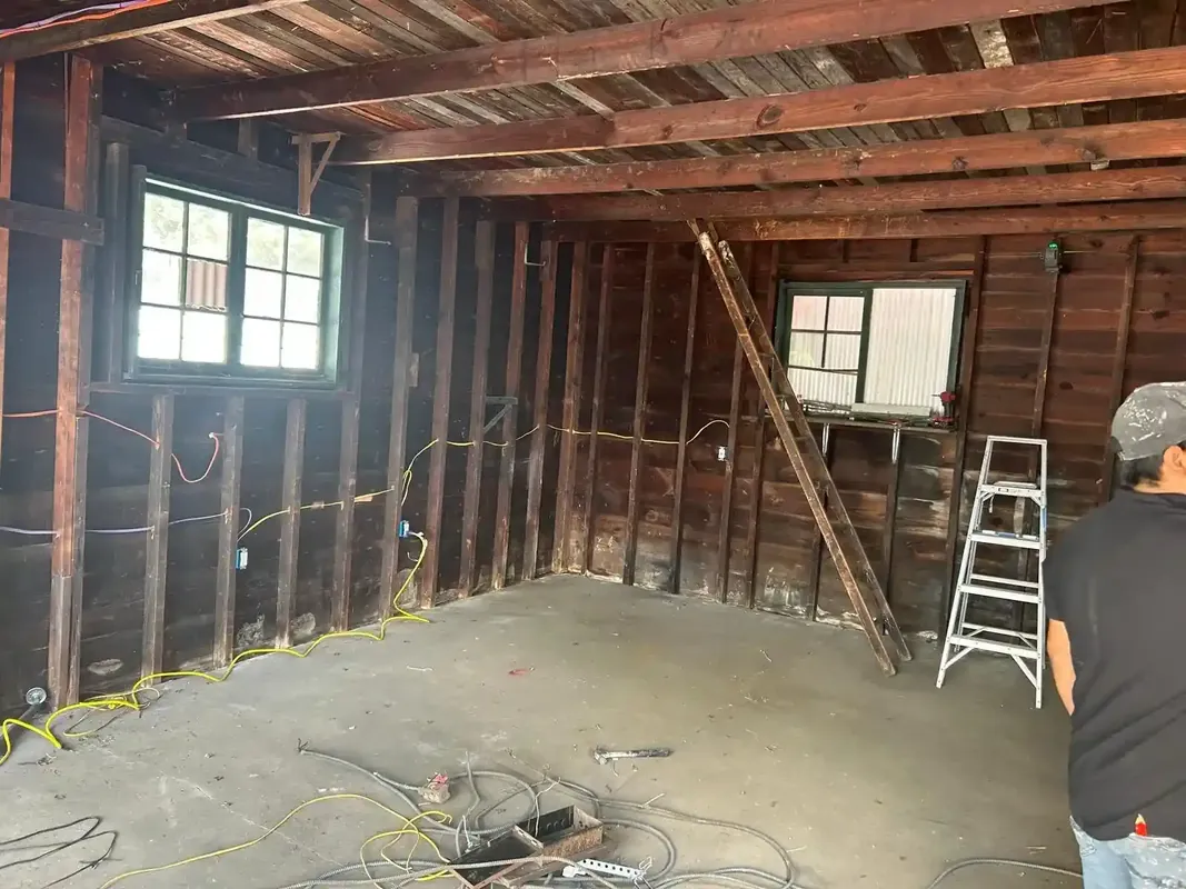 Interior rough framing room with exposed wood beams and new wiring