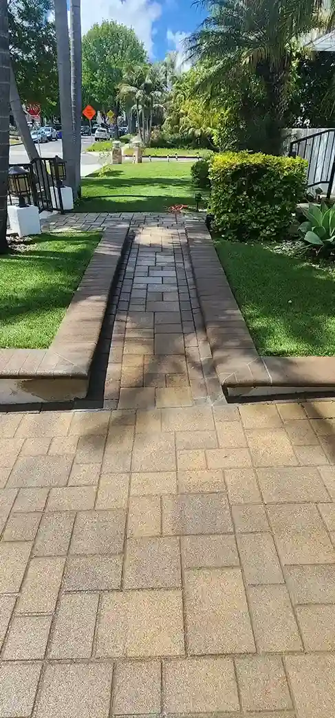 Paver walkway with brick steps, green lawn and tropical landscaping in Brooklyn NY