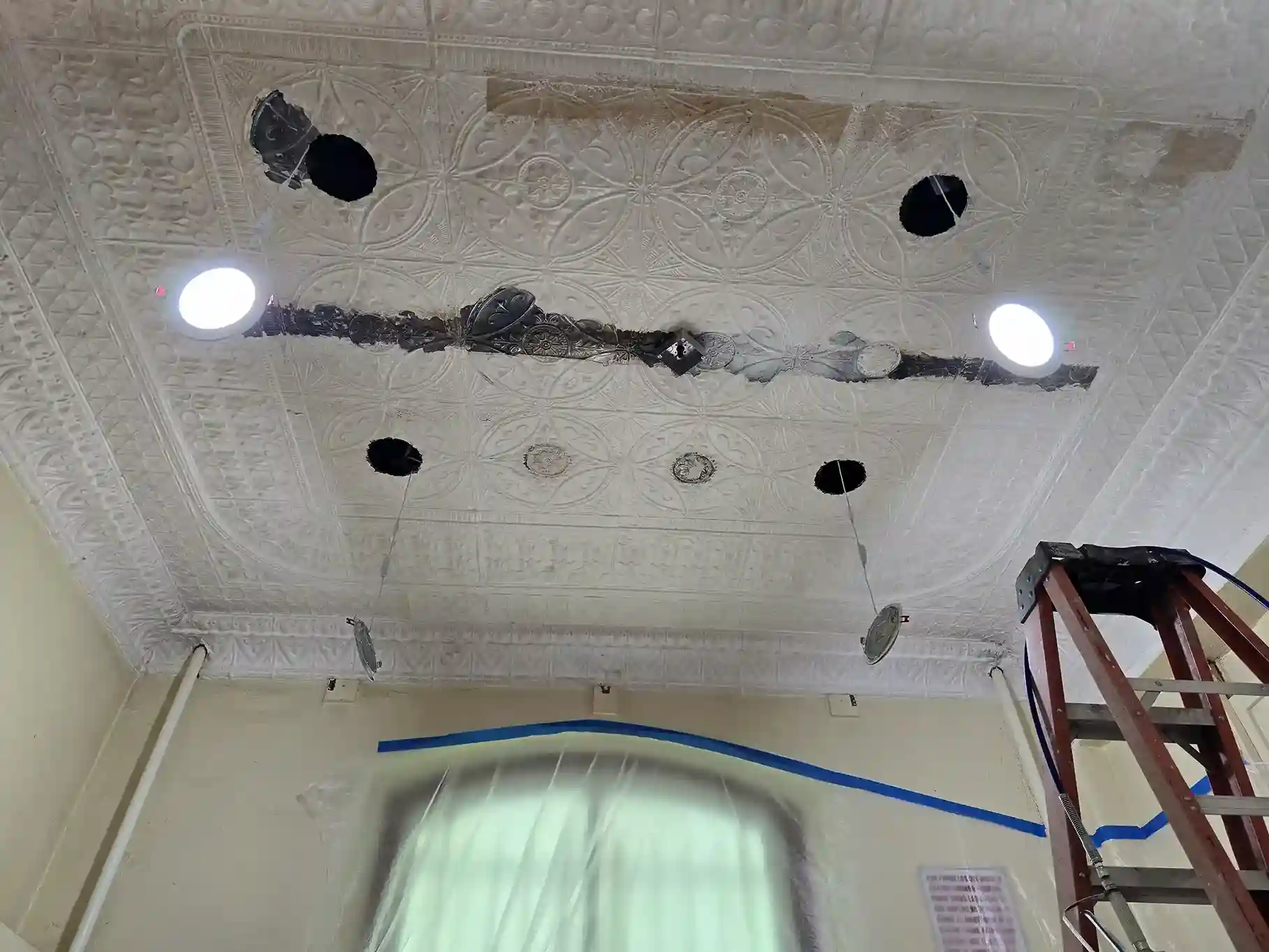 Ornate tin ceiling renovation with recessed lighting installation in Brooklyn home by DJ Luxury Renovations